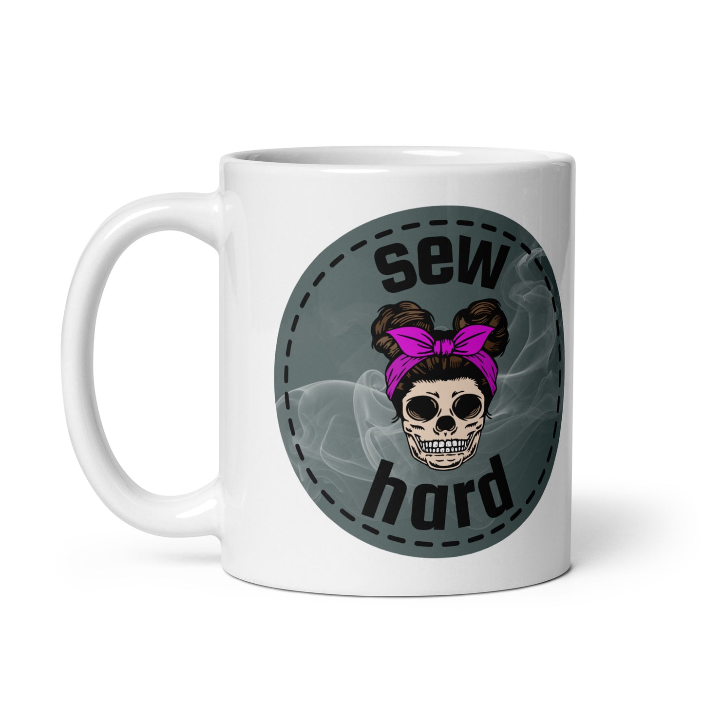 White ceramic mug with Sew Hard skull design featuring pigtail buns, pink bow, and smoky sage green background – sewing gift for quilters and sewists