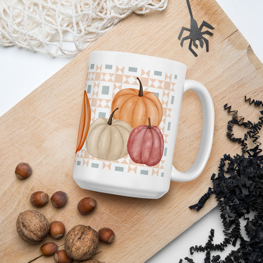 Glossy patchwork pumpkin mug with quilt pattern background – fall quilting coffee cup gift for sewists