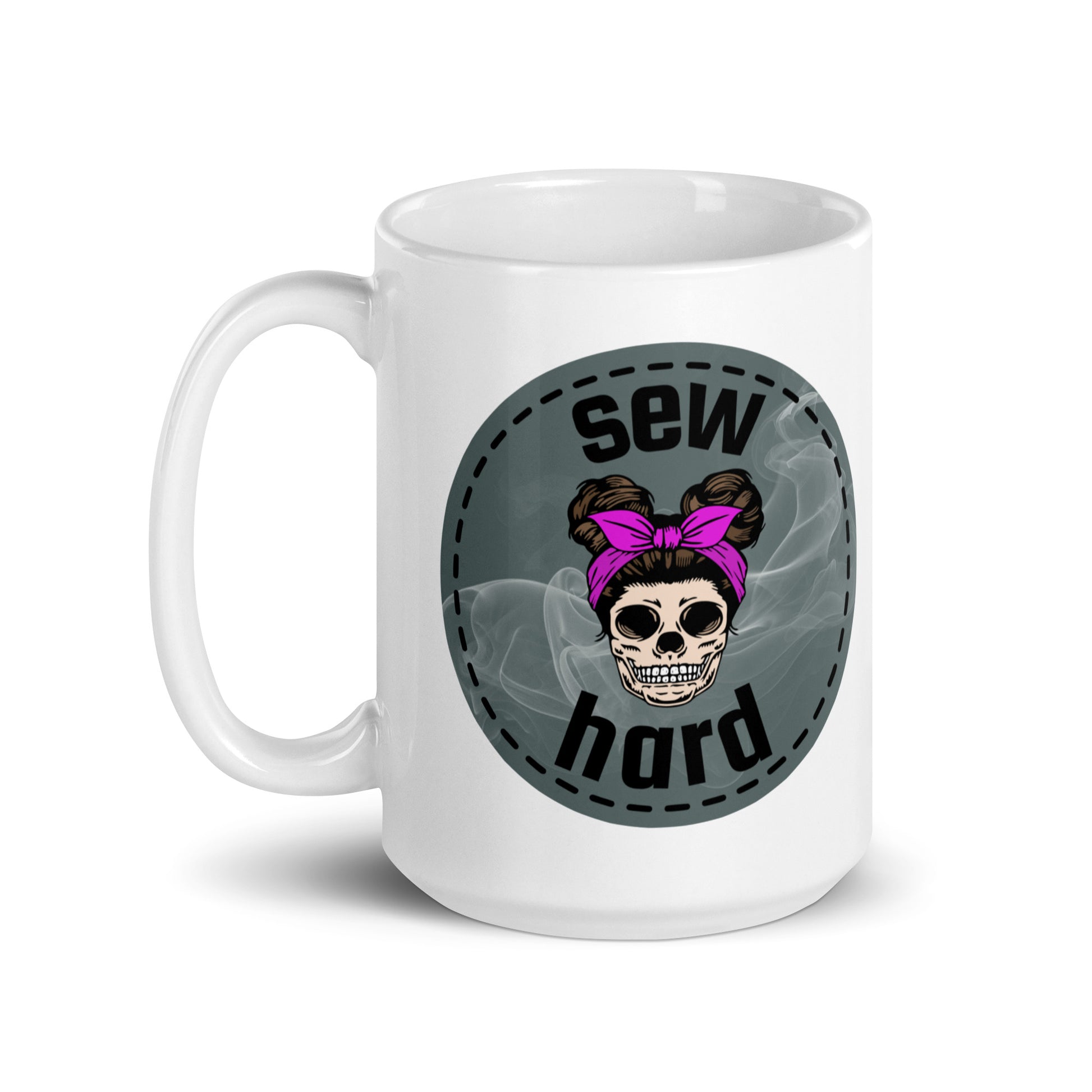 White ceramic mug with Sew Hard skull design featuring pigtail buns, pink bow, and smoky sage green background – sewing gift for quilters and sewists